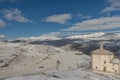Top view of the snowy mountains of Abruzzo and the church of Santa Maria della Piet Royalty Free Stock Photo
